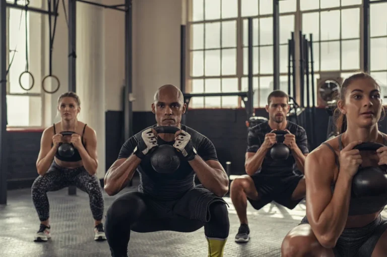 fitness items for swinging crossword clue — answer is KETTLEBELLS shown on gym floor